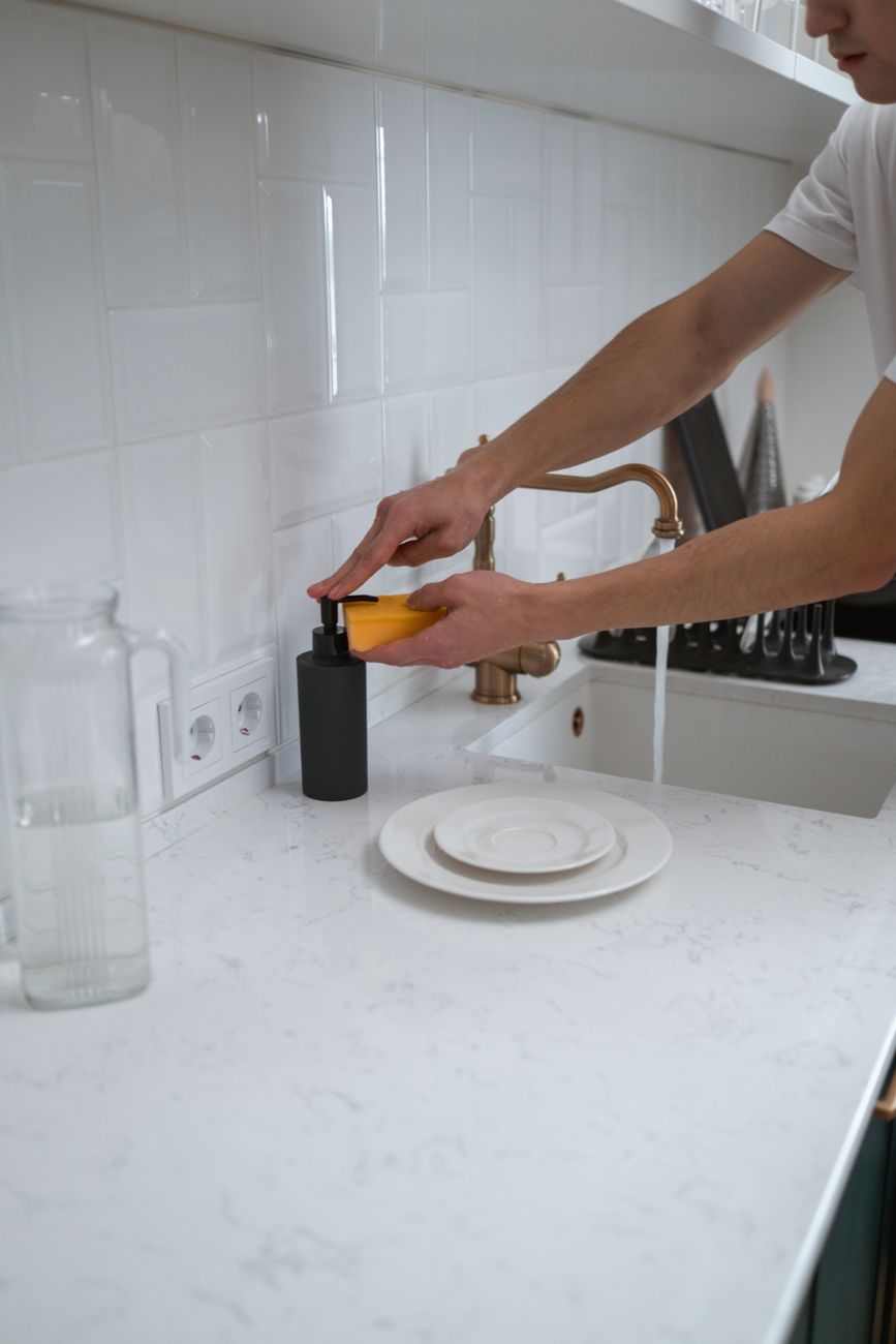 Cleaner wiping the edge of a wooden floor by hand